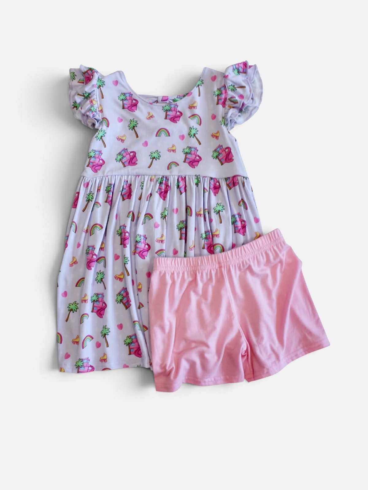 Girls' lavender dress with matching pink shorts, flutter sleeves, and yellow roller-skates, rainbows, palm trees, and a doll dream house 