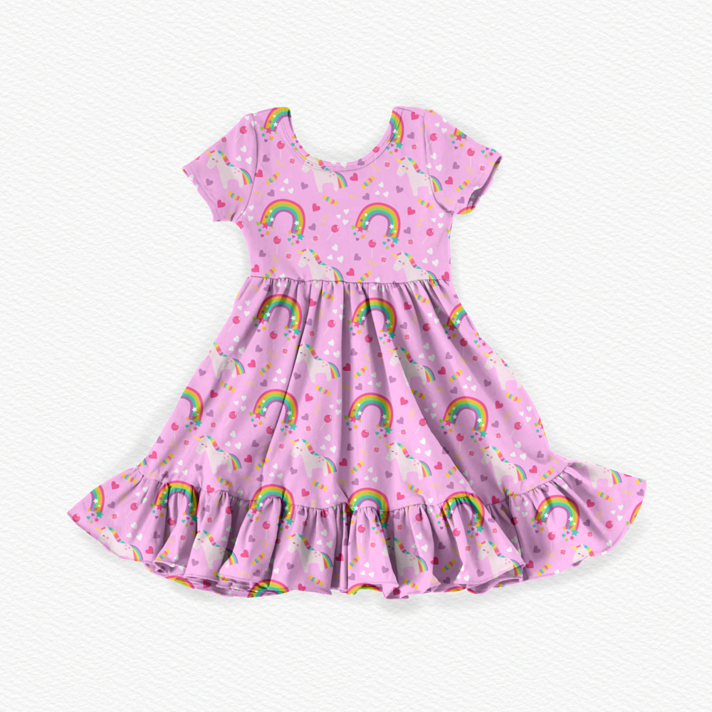Pink girls' bamboo viscose twirl dress featuring colorful unicorns, rainbows, hearts, and stars with short sleeves, a gathered waist, and a playful ruffled hem.