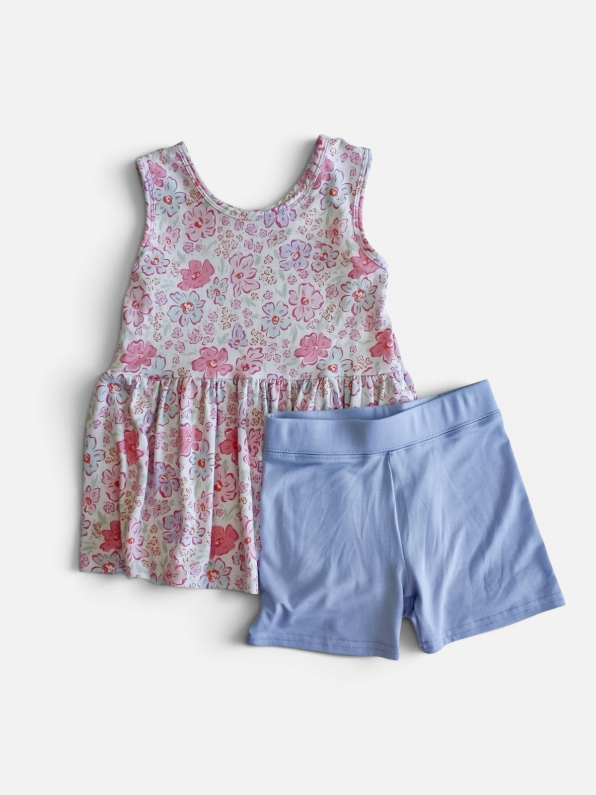 Polly & Pearl toddler outfit set featuring a floral print sleeveless tunic and solid periwinkle blue shorts.